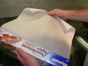 Begin by tearing a piece of parchment paper from the roll...