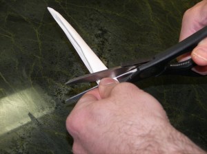 Cut paper just above your fingers...